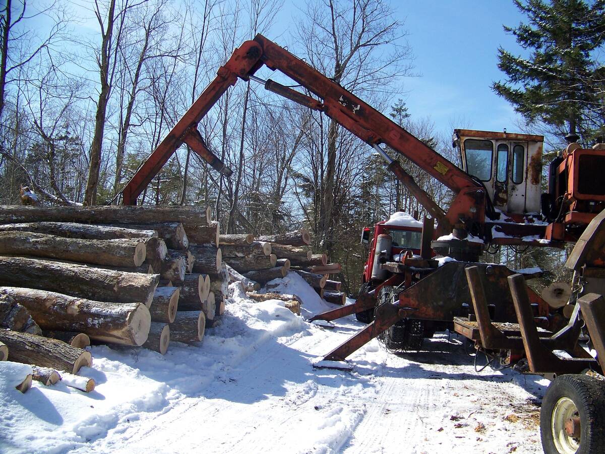 Log loader working in snow